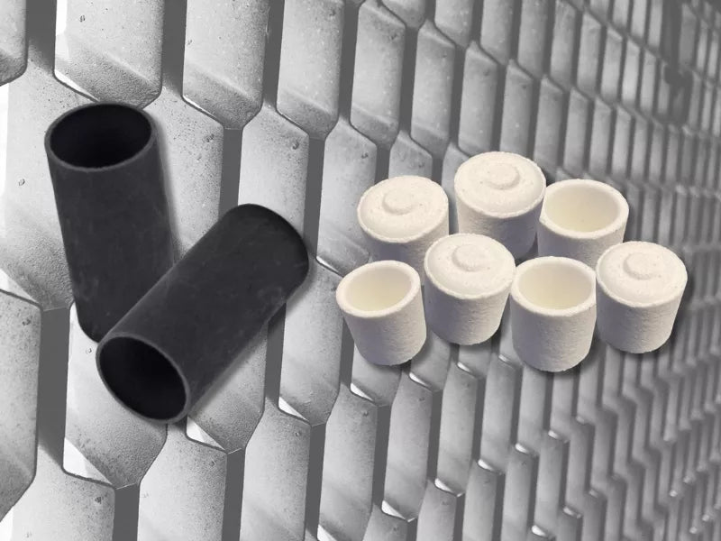 Photo of Ceramic and graphite crucibles on a metal background