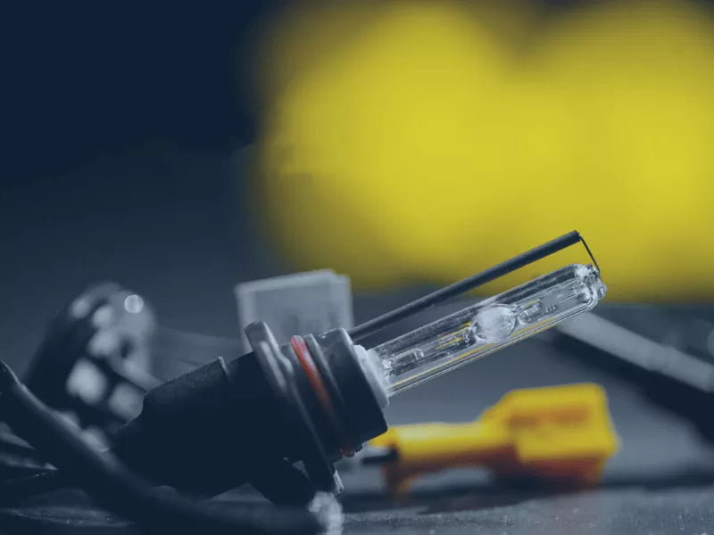 Photo of a black xenon lamp with a yellow background