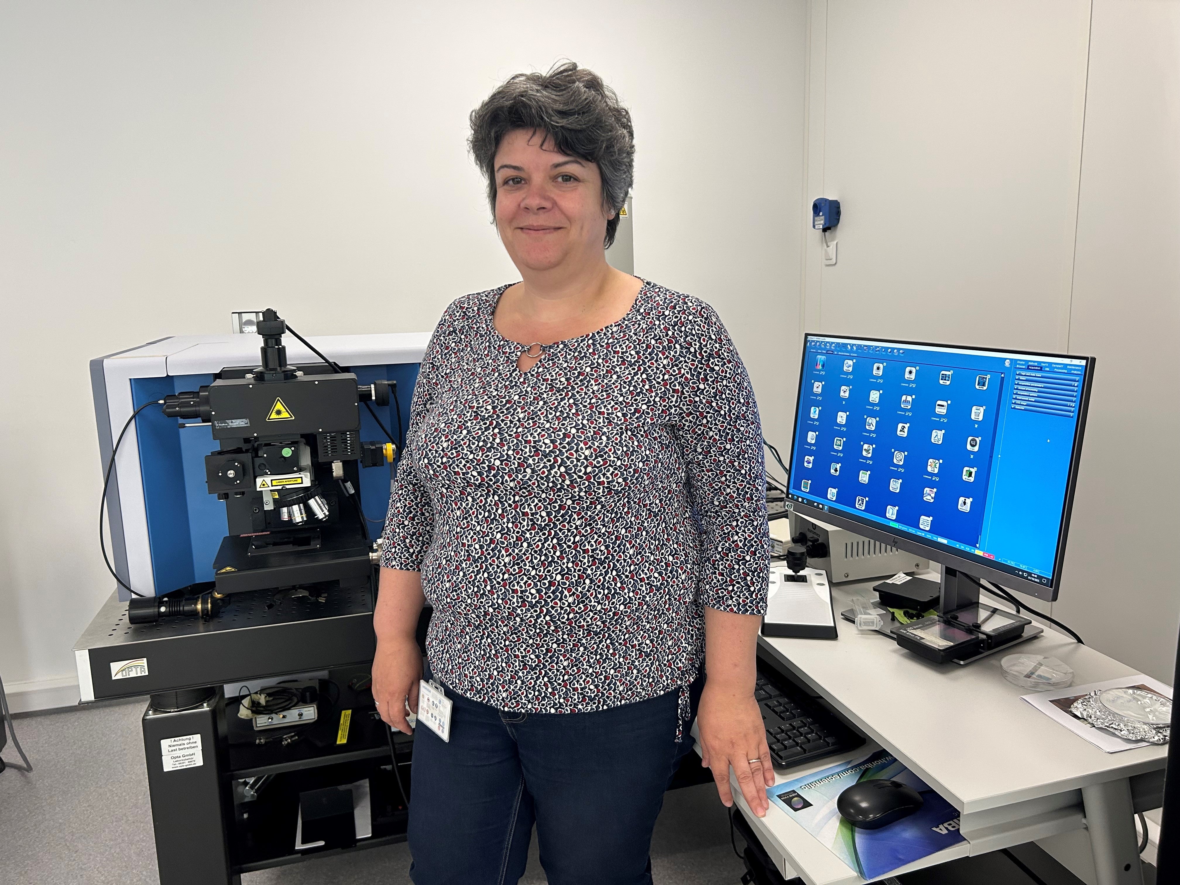 Photo of Céline Eypert, our Raman Expert, Product application specialist, and Trainer for all Raman training in HORIBA France behind a LabRAM HR Evolution instrument