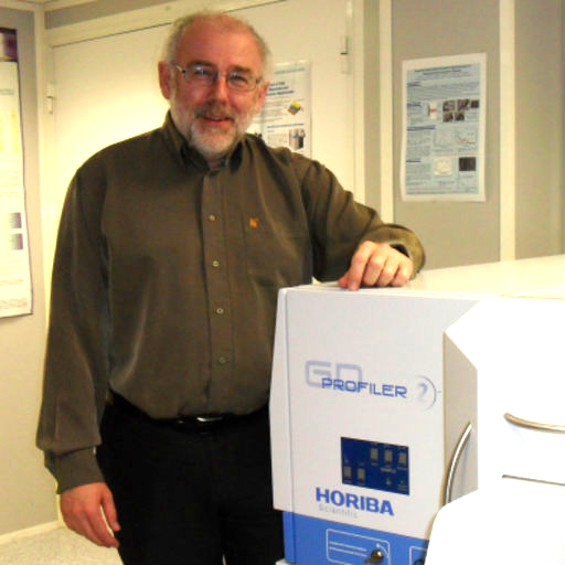 Photo of Patrick Chapon, expert in GD-OES, next to his GD Profiler 2 instrument.